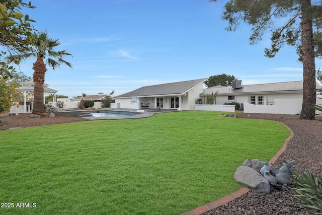 back of house featuring a yard and a patio area