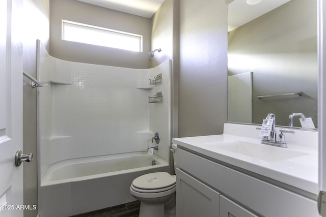 full bathroom featuring tiled shower / bath combo, vanity, and toilet