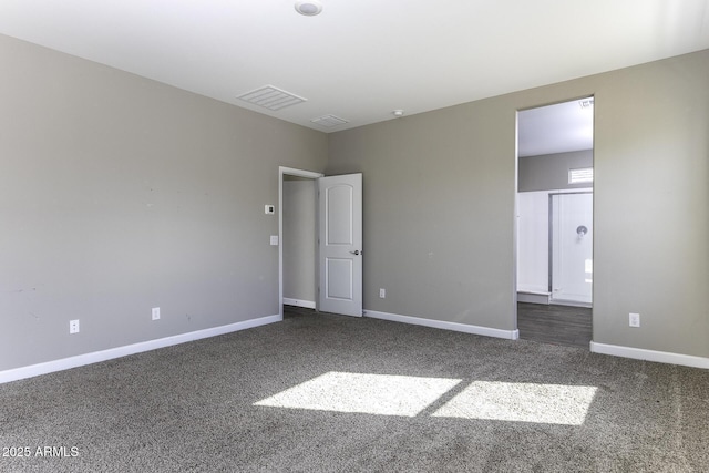 unfurnished bedroom with dark carpet