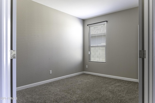 empty room with dark colored carpet