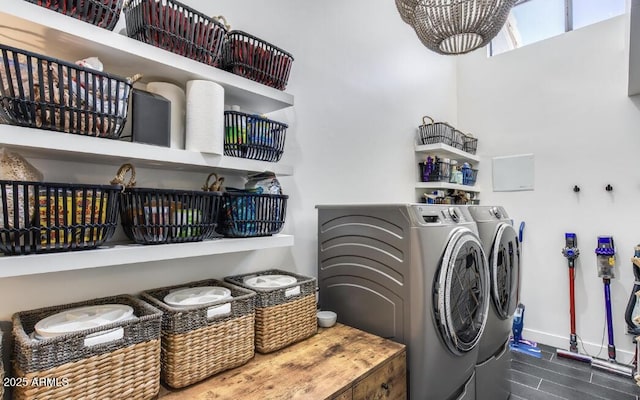 laundry area with washer and dryer, laundry area, dark wood finished floors, and baseboards