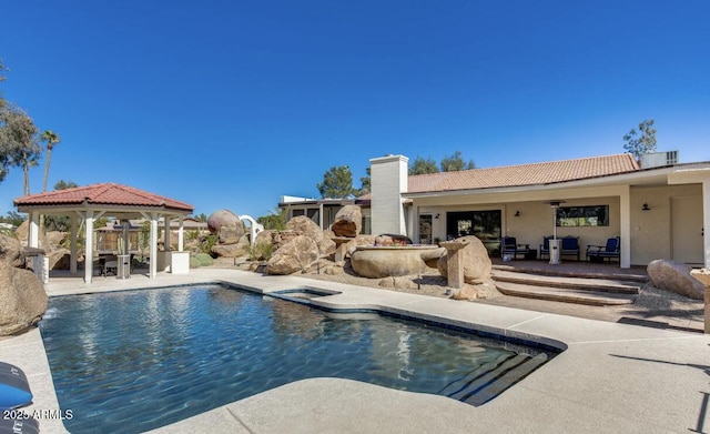 outdoor pool with ceiling fan, a gazebo, central AC unit, and a patio area