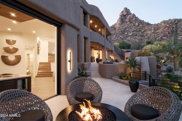 view of patio / terrace featuring a fire pit and a mountain view