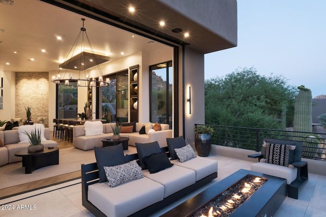 patio terrace at dusk featuring an outdoor living space with a fire pit