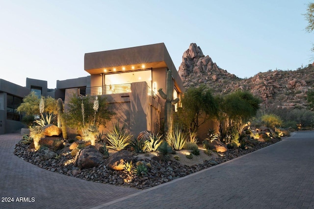 view of home's exterior featuring a mountain view and a balcony