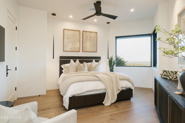 bedroom featuring ceiling fan and light hardwood / wood-style flooring