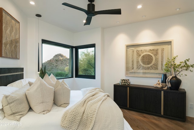 bedroom with ceiling fan and dark wood-type flooring