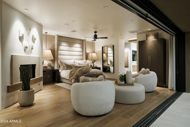 bedroom with ceiling fan and light hardwood / wood-style flooring