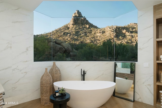 exterior space featuring a tub to relax in and tile walls