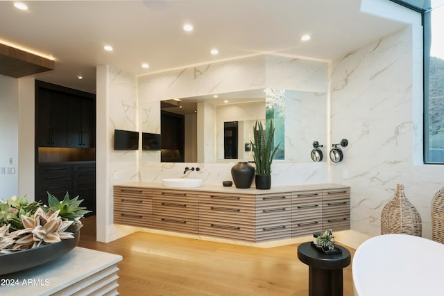 bathroom featuring decorative backsplash, hardwood / wood-style floors, and vanity