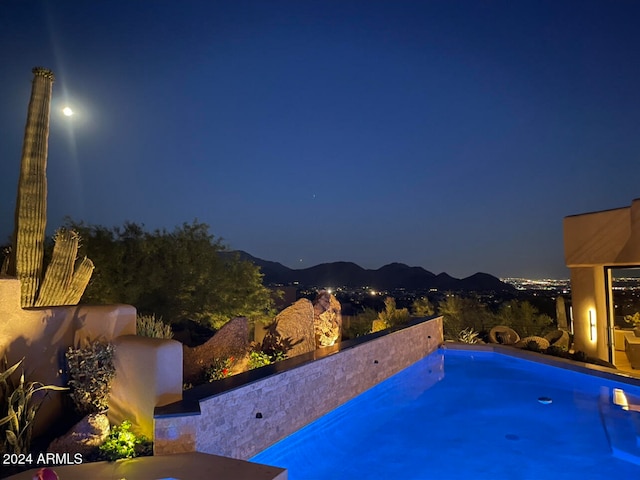 pool at twilight with a mountain view