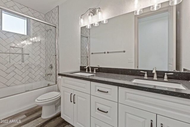 0000 W Hooper Trl Unit 3, Queen Creek, AZ 85144 - full bathroom with enclosed tub / shower combo, toilet, wood finished floors, and a sink