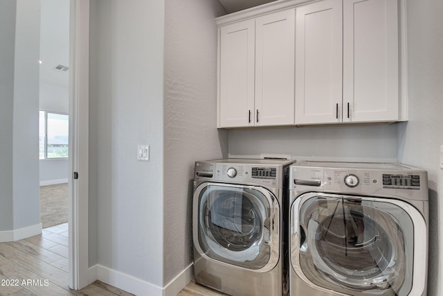 0000 W Hooper Trl Unit 3, Queen Creek, AZ 85144 - laundry area with light wood-type flooring, cabinet space, visible vents, and washing machine and clothes dryer