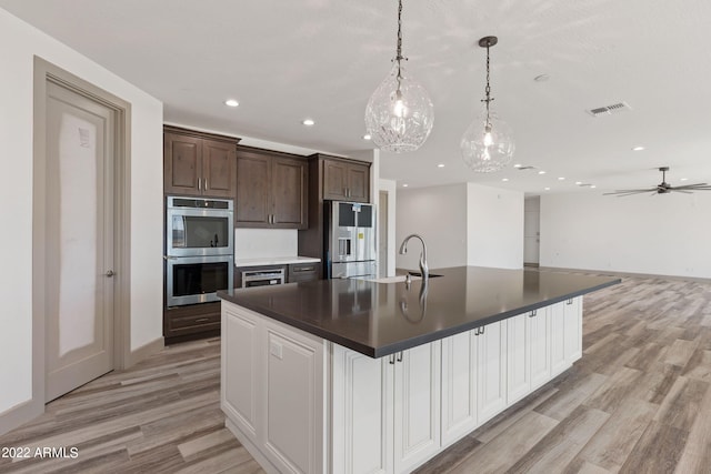 0000 W Hooper Trl Unit 3, Queen Creek, AZ 85144 - kitchen featuring dark countertops, visible vents, a spacious island, stainless steel appliances, and a sink