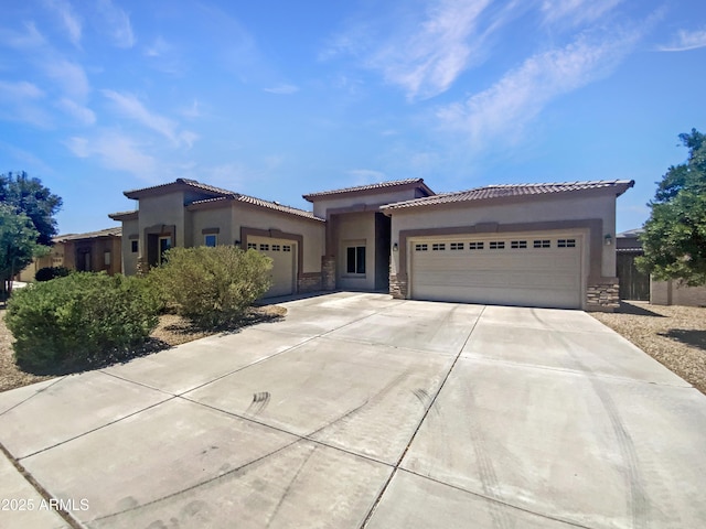 2971 N Rosewood Ave, Casa Grande, AZ 85122 - mediterranean / spanish-style house with a garage, stone siding, driveway, and stucco siding
