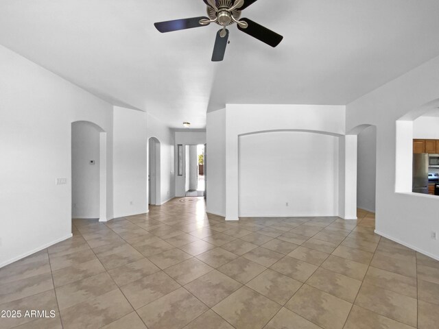 2971 N Rosewood Ave, Casa Grande, AZ 85122 - unfurnished living room with arched walkways, a ceiling fan, and light tile patterned floors