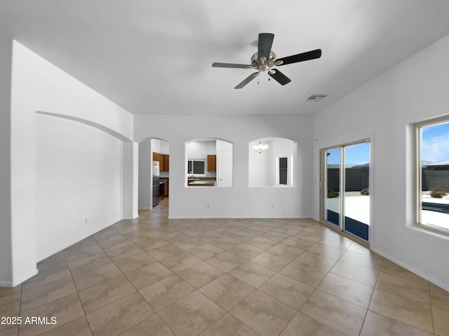 2971 N Rosewood Ave, Casa Grande, AZ 85122 - spare room featuring arched walkways, light tile patterned floors, a ceiling fan, and baseboards