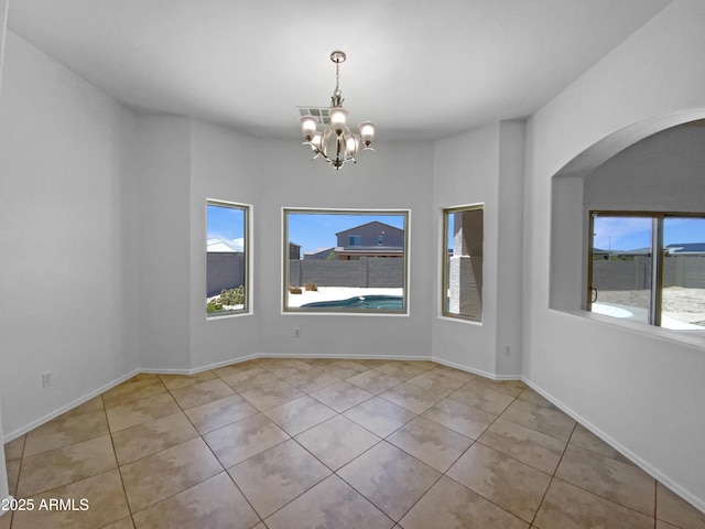 2971 N Rosewood Ave, Casa Grande, AZ 85122 - unfurnished dining area with arched walkways, a chandelier, tile patterned flooring, and baseboards