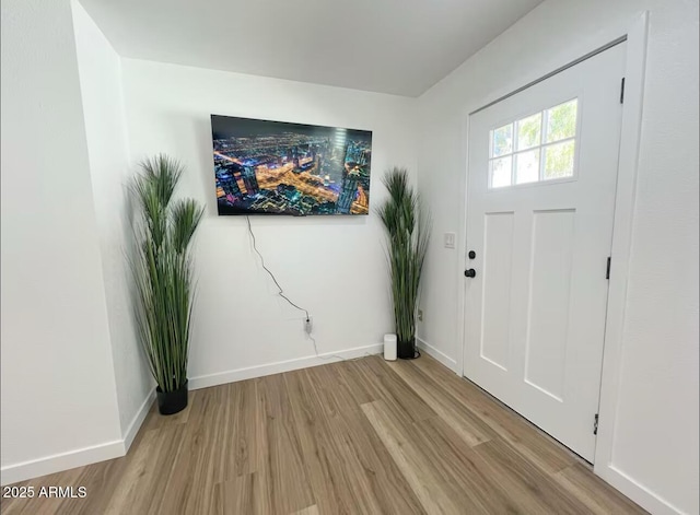 foyer featuring baseboards and light wood-style floors