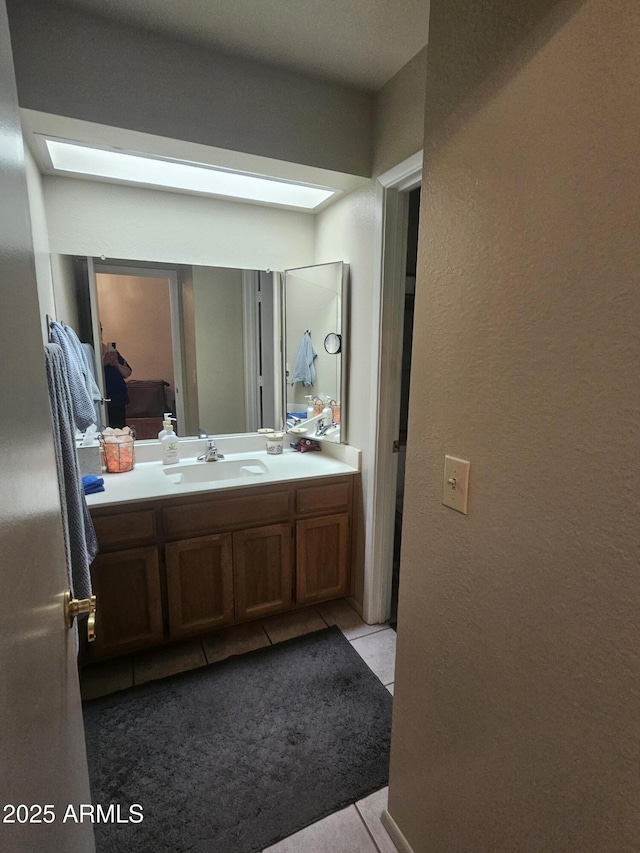6036 W Mescal St, Glendale, AZ 85304 - bathroom featuring tile patterned flooring, vanity, and a textured wall