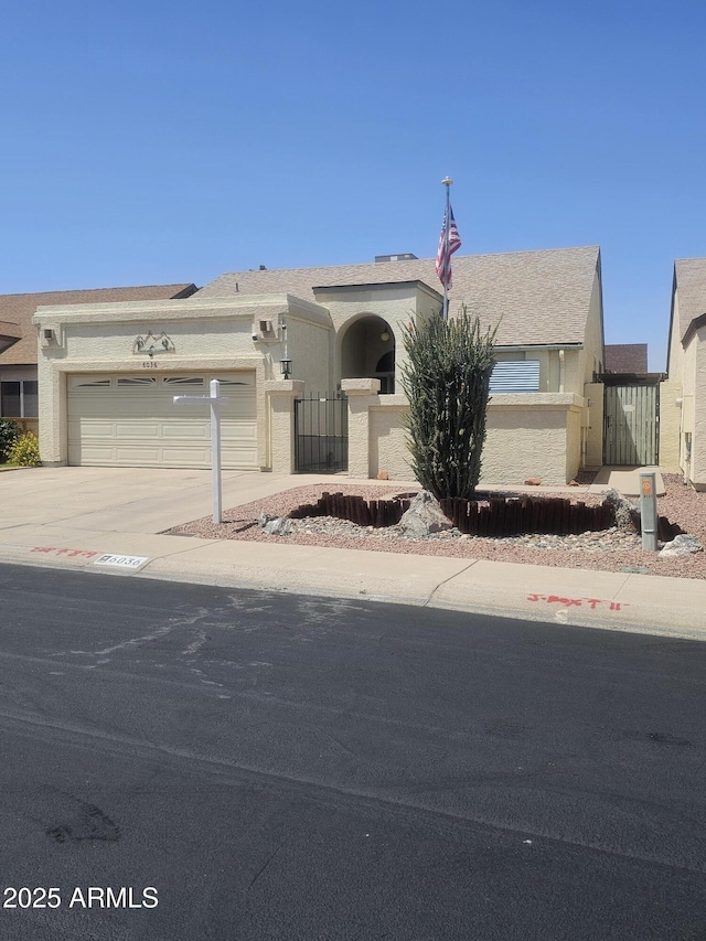 6036 W Mescal St, Glendale, AZ 85304 - view of front of property featuring an attached garage, concrete driveway, and stucco siding