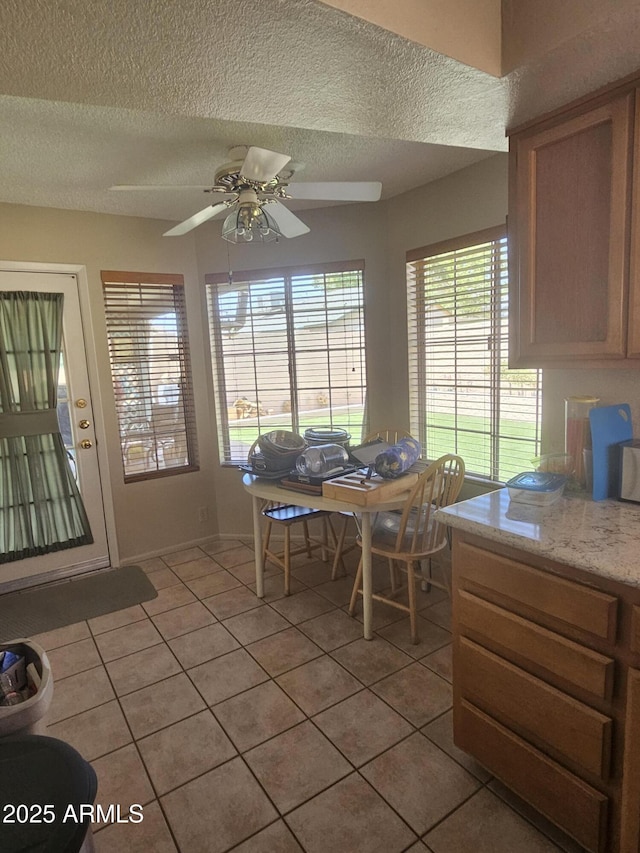 6036 W Mescal St, Glendale, AZ 85304 - dining area featuring light tile patterned flooring, a textured ceiling, and ceiling fan