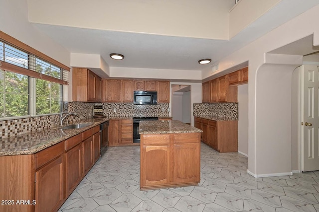 6928 W Oraibi Dr, Glendale, AZ 85308 - kitchen with black appliances, a sink, dark stone counters, light marble finish floors, and recessed lighting