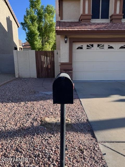 6928 W Oraibi Dr, Glendale, AZ 85308 - exterior space featuring a garage, concrete driveway, and brick siding
