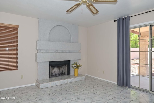 6928 W Oraibi Dr, Glendale, AZ 85308 - unfurnished living room with ceiling fan, marble look tiles, a fireplace, and baseboards
