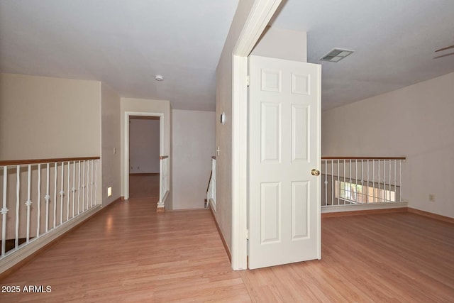 6928 W Oraibi Dr, Glendale, AZ 85308 - corridor with wood finished floors, baseboards, and an upstairs landing