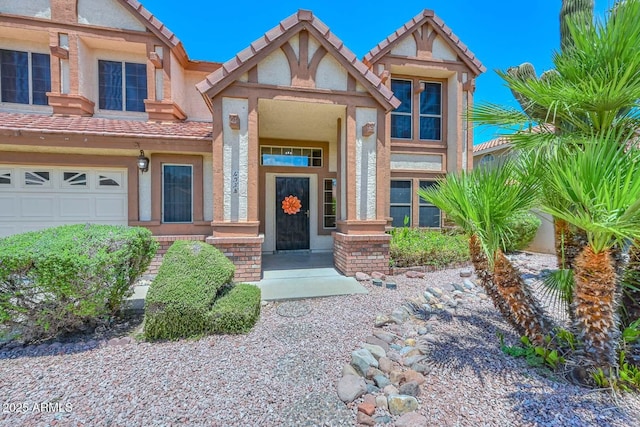 6928 W Oraibi Dr, Glendale, AZ 85308 - view of front of property with stucco siding, a tile roof, and an attached garage