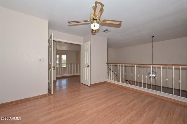 6928 W Oraibi Dr, Glendale, AZ 85308 - empty room featuring light wood finished floors, a ceiling fan, and baseboards