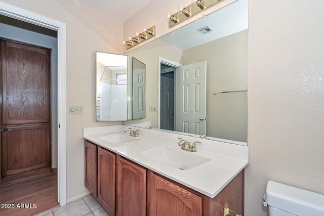 6928 W Oraibi Dr, Glendale, AZ 85308 - full bathroom with double vanity, toilet, and tile patterned floors