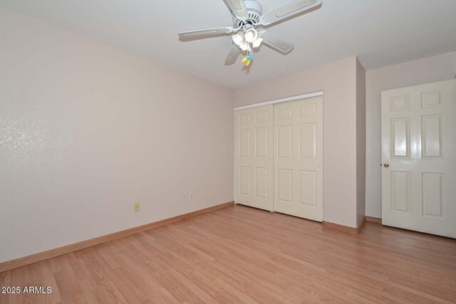 6928 W Oraibi Dr, Glendale, AZ 85308 - unfurnished bedroom with baseboards, light wood-style floors, a closet, and a ceiling fan