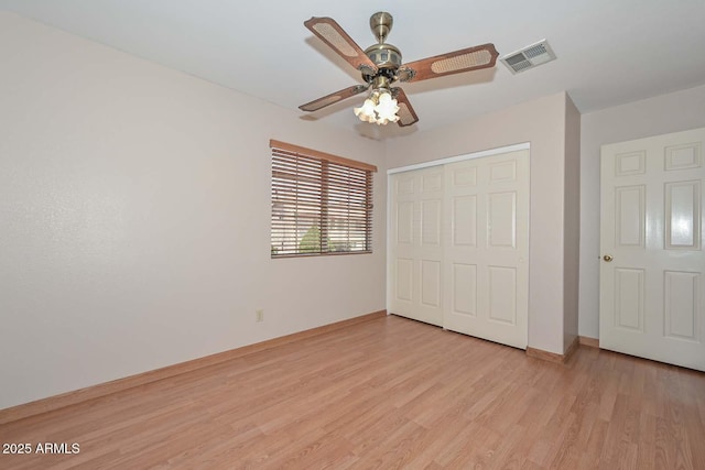 6928 W Oraibi Dr, Glendale, AZ 85308 - unfurnished bedroom featuring light wood-style floors, a closet, baseboards, and ceiling fan