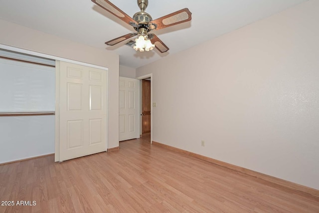 6928 W Oraibi Dr, Glendale, AZ 85308 - unfurnished bedroom featuring light wood-type flooring, baseboards, a closet, and a ceiling fan
