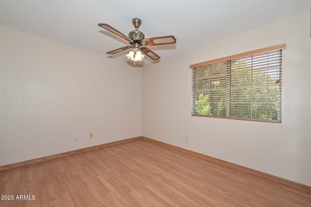 6928 W Oraibi Dr, Glendale, AZ 85308 - empty room featuring light wood-style flooring, plenty of natural light, a ceiling fan, and baseboards
