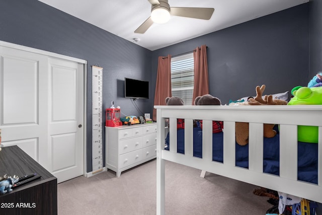 bedroom featuring ceiling fan and light carpet