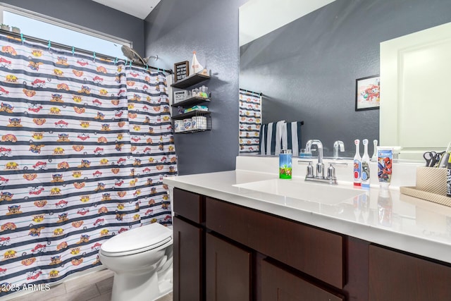 full bathroom featuring vanity, wood finished floors, curtained shower, toilet, and a textured wall