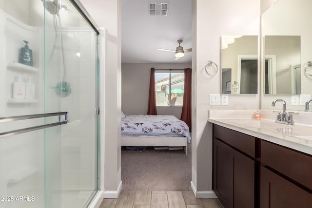 ensuite bathroom with a stall shower, visible vents, ensuite bath, and vanity