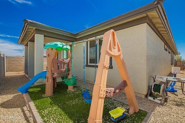 view of playground featuring fence