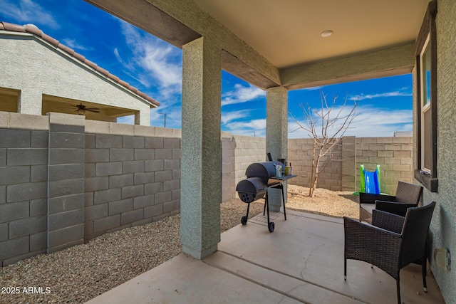 view of patio with a fenced backyard and a grill