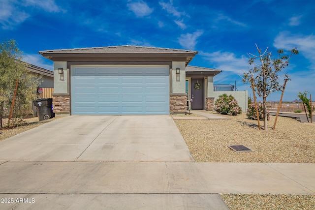 prairie-style home featuring stucco siding, stone siding, and concrete driveway