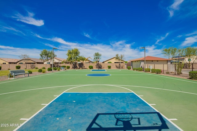 view of sport court featuring a residential view, community basketball court, and fence