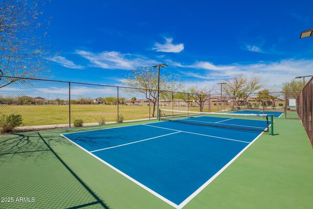 view of sport court featuring fence