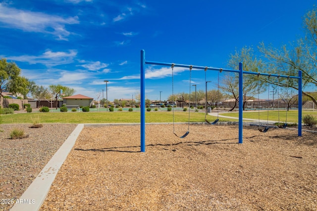 view of property's community featuring a yard and playground community