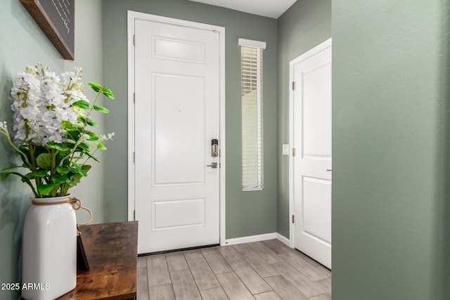 entrance foyer featuring wood finish floors and baseboards