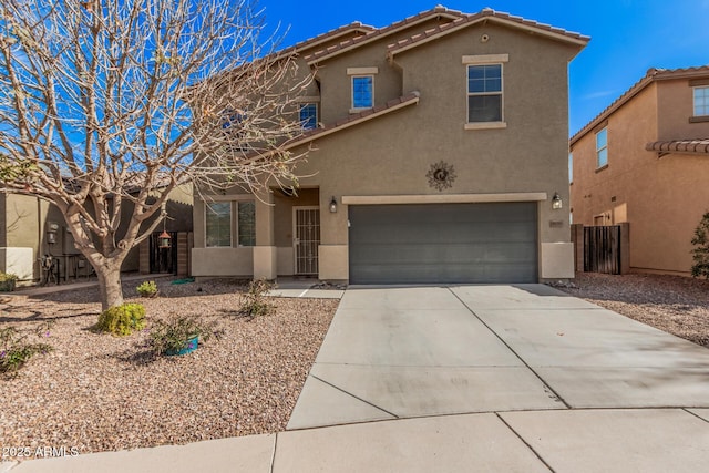 view of front facade featuring driveway, a tiled roof, a garage, and stucco siding