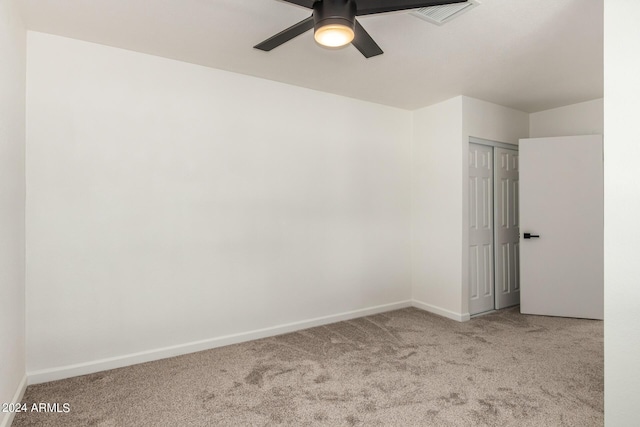 carpeted empty room with ceiling fan