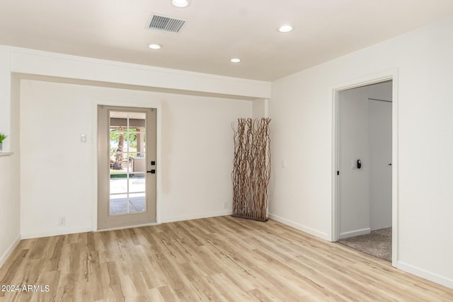 unfurnished room with light wood-type flooring